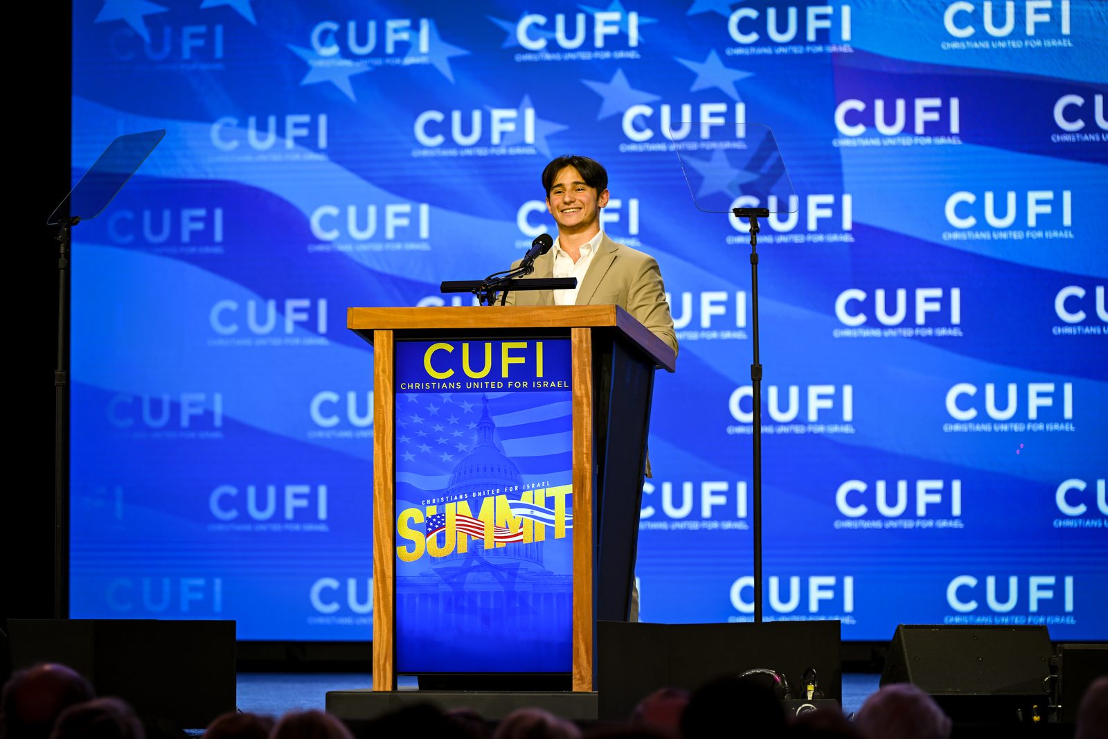 Sam Salz at the podium at the CUFI Summit.