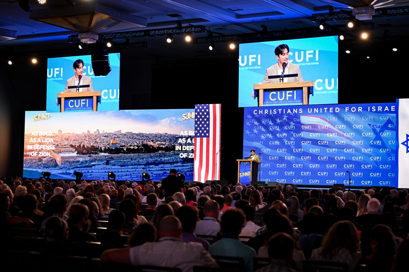Sam Salz speaking to a large audience at the CUFI Summit.