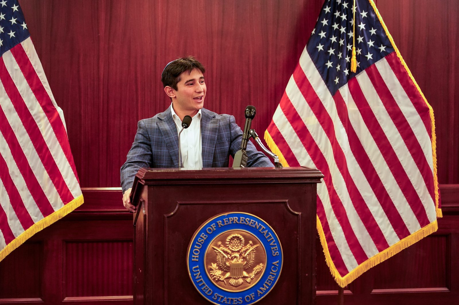 Sam Salz smiling while speaking at the U.S. House of Representatives.